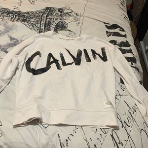 White Calvin Klein sweater with black “Calvin” imprinted on front